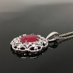 14K Ruby and Diamond Pendant METAL: 14K White Gold TOTAL WEIGHT: 1.7 g DIAMONDS: Round Brilliant Cut Diamonds COLOR: G/H CLARITY: VS2-SI1 TOTAL WEIGHT: 0.16 ct RUBY: Genuine Oval Cut Ruby MEASUREMENTS: 8mm x 6mm TOTAL WEIGHT: 1.40 ct Chain Length: 16, 18, or 20 inch chain is included with your purchase. Please indicate your desired length at checkout. DESCRIPTION: Beautiful Ruby and diamond pendant. This item has a lot of vintage flair. It looks gorgeous on. It's a little under an inch in length Oval Diamond Filigree Necklace, Oval Diamond Necklace With Intricate Design, Oval White Gold Necklace With Intricate Design, Luxury Oval Necklace With Intricate Design, Evening Ruby Jewelry, Round Shape, Oval Fine Jewelry Necklace With Intricate Design, Elegant White Gold Ruby Necklace, Elegant Ruby Round Pendant Jewelry, Luxury Necklace With Intricate Design For Anniversary