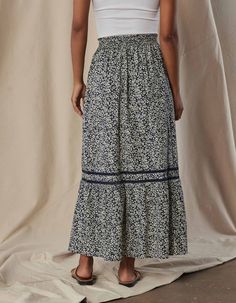 Yes, it has pockets! This cotton skirt boasts a luxurious and smooth texture, providing a soft, crisp feel against your skin. The intricate ladder lace trim adds a touch of sophistication and elevates the overall design. The shirred waistline, complete with a ruffle at the top, creates a flattering silhouette while pockets in the side seams add utility to this maxi skirt. Fit: True to size. Maxi length Fabric Details: Camp Cotton Poplin Fabric Content: 100% Cotton Details: Elastic waist with ruf Ruffle Maxi Skirt, Henley Sweater, Cotton Poplin Fabric, Tier Skirt, Cotton Skirt, Overall Dress, Fall Shopping, Fabric Details, Tiered Skirt