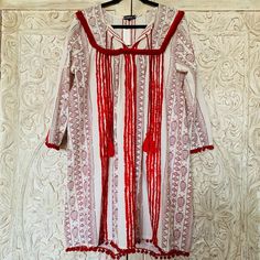 Anthropologie Joselle Chantik Brand Bohemian Dress -Nwt -Beautiful And Bright Summer Dress That Can Be Dressed Up Or Down - Amazing Vacation Dress -100% Cotton -Stunning Tassle And Embroidery Details -Long Sleeve -Approx. Knee Length - Size Large Festive Tunic Dress With Tassels, White Peasant V-neck Dress, Red Bohemian Dress For Festive Occasions, Traditional White Dress With Back Tassel Tie-up, Festive Bohemian Red Dress, Festive White Tunic Dress, Folk Style Red Long Sleeve Dress, Red Folk Style V-neck Dress, Red Folk Tunic Dress