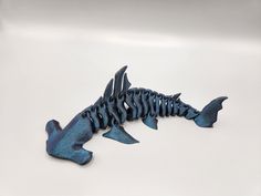 a blue fish skeleton on a white surface