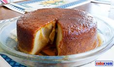 a cake that has been cut in half on a glass plate with another piece missing