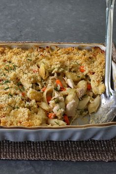 a casserole dish with chicken, carrots and parmesan bread crumbs