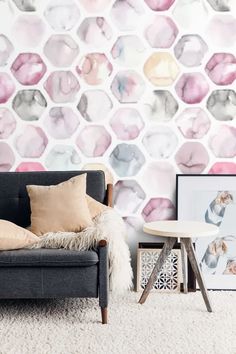 a living room scene with focus on the couch and wallpaper that looks like hexagon tiles