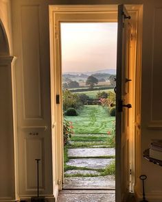 an open door leading to a lush green field