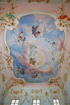 an ornate painted ceiling in a pink room