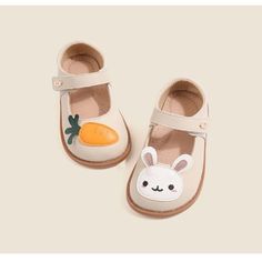 Introducing our Cartoon Rabbit Leather Flat Shoes – the perfect blend of comfort, style, and whimsical charm. Crafted with your little one's comfort in mind, these flat shoes are made from high-quality leather that's gentle on their delicate feet. The star of the show is our adorable cartoon rabbit or carrot design, adding a playful touch to your child's footwear collection. The strap ensures a secure fit, so your little explorer can hop and skip with ease while wearing these delightful shoes. W Cream Closed Toe Leather Shoes For Spring, Cute Pink Mary Janes For Spring, Playful Non-slip Sandals With Round Toe, Spring Cream Leather Shoes With Rubber Sole, White Leather Ballet Flats With Round Toe, Cute Mary Janes With Round Toe For Spring, Cute Spring Mary Janes With Round Toe, Spring Cute Mary Janes With Round Toe, White Mary Janes With Soft Sole For Spring