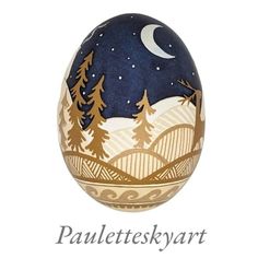 an egg with trees and mountains painted on it