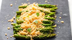 cooked asparagus with parmesan cheese and seasoning sprinkled on top