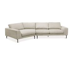 a white sectional couch sitting on top of a white floor