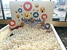 three men standing in front of a fake facebook sign made out of eggs and marshmallows