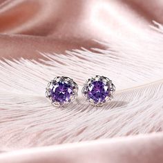 Sparkling and elegant, these purple stud earrings are perfect for that special evening out. Created in sterling silver, each earring features a round cut stone sparking at its center, while additional round stones line the sterling silver settings for extra shimmer. An imaginative look you'll adore, these earrings are unsurpassed with magnificence and sparkle.Carat Weight: 7.2 ctStone Size: 8 mmStone Type: Jeulia® StoneNumber of Stones: 2 Stone Color: Amethyst PurpleStone Shape: RoundCarat Weigh Elegant Purple Pierced Earrings, Elegant Purple Earrings For Pierced Ears, Elegant Amethyst Earrings, Elegant Round Purple Jewelry, Elegant Purple Pierced Jewelry, Lavender Fine Jewelry Earrings For Formal Occasions, Formal Lavender Gemstone Earrings, Elegant Purple Round Jewelry, Formal Lavender Amethyst Earrings