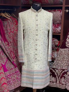 Mint green sherwani blooms with fine jaal pattern charmed with off white resham beautifies with mirror work and embroidered border and while the mandarin collar is enriched with zardosi and sequins for a marvelous finish.paired with a matching churidar pants. Size: 38,42,44,46 Ready to Ship! Pista Green Cotton Sherwani With Resham Embroidery, Unstitched Pista Green Sherwani With Resham Embroidery, Pista Green Fitted Sherwani With Cutdana, Pista Green Semi-stitched Sherwani With Resham Embroidery, White Semi-stitched Sherwani With Mirror Work, Green Sherwani, Pakistani Wear, Western Gown, Green Thread