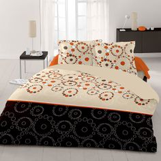 an orange and black comforter with circles on it