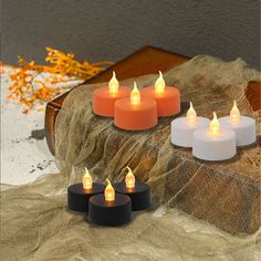 six lit candles sitting on top of a table