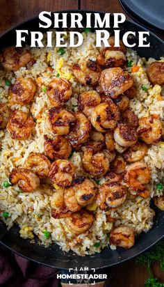 shrimp fried rice in a skillet on top of a wooden table