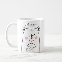 a white coffee mug with a cartoon bear on it's face and name juliana