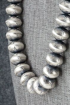 This sterling silver Navajo pearl necklace was made by Navajo silversmith Bryannen Halwood.Necklace: 17"Bead size: 5/8" x 1/2"Free shipping on all orders! We ship with USPS and always include tracking. All orders ship within a day of payment.Returns are accepted up to 30 days after you receive your order. Just send us a message. Our shop offers cash back or store credit. The item must be returned in new condition. Southwestern Silver Necklace With Large Beads, Western Silver Engraved Necklaces, Western Style Silver Engraved Necklace, Western Style Engraved Silver Necklace, Southwestern Style Silver Necklace With Large Beads, Southwestern Silver Beaded Necklace With Large Beads, Southwestern Style Silver Beaded Necklace With Large Beads, Southwestern Sterling Silver Concho Necklace, Silver Artisan Necklace With Concho