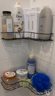 two shelves above a bathroom sink filled with toiletries and shampoos on it