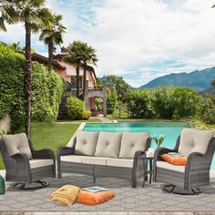 an outdoor patio furniture set near a swimming pool