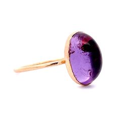 This modern minimalist 1.24 Amethyst Cocktail Ring is crafted in 14K Yellow Gold. A purple treasure to honor Minneapolis. It features a 14 karat yellow gold bezel setting, with a cabochon cut amethyst weighing 1.24 carats. The amethyst is mounted on a thin, yellow gold band, making it a perfect piece for everyday wear. This ring is sure to be a favorite for any minimalist fashion lover. Amethyst symbolizes peace and unity. A gorgeous ring for every day of the week! Amethyst Cocktail Ring, Gorgeous Ring, Metal Shop, Shop Engagement Rings, Gold Band, Cocktail Ring, Cocktail Rings, Yellow Gold Rings, Bezel Setting