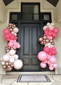 the front door is decorated with balloons and streamers for an elegant touch to this entrance