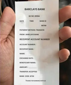 someone is holding up a fake bank card in their hand with the receipt printed out