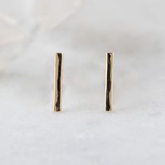 simple, edgy + modern. These minimal fine metal bar earrings are a perfect addition to your ear stack! Adding a modern + edgy vibe. Earring Specifications: hand-crafted gold bar studs measure 10 x 2mm lightly hammered + polished finish choose from 14k gold, gold filled or sterling silver Stud Earrings Gold, Bar Stud Earrings, Ear Stack, Bar Studs, Metal Bar, Bar Earrings, Gold Bar, Gold Earrings Studs, Gold Gold