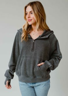 The sweatshirt you'll be living in all year long! Our new comfy charcoal gray hooded sweatshirt is there perfect option for casual wear. Charcoal gray hooded sweatshirt Quarter zipper closure on the front Long sleeves with thumbholes Front kangaroo pocket Slightly cropped hemline Model is wearing a size small  Designed in the U.S.A. Produced in China. 60% Cotton / 40% Polyester Gray Comfortable Hoodie, Gray Cozy Fit Sweats, Comfortable Gray Hoodie With Drawstring Hood, Comfy Gray Hooded Sweats, Comfortable Soft-washed Hoodie For Fall, Soft-washed Comfortable Fall Hoodie, Fall Comfortable Soft-washed Hoodie, Comfortable Soft-washed Fall Hoodie, Gray Cozy Hoodie With Drawstring