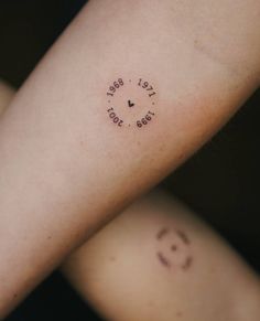 two people with small tattoos on their arms