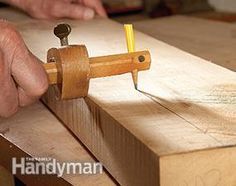 a person working on a piece of wood with a vise and a small tool