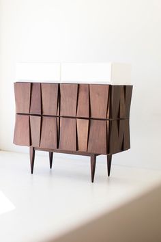 the sideboard is made out of wood and has geometric shapes on it's sides