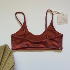 The Brecken top is a functional bralette style top that is perfect for the active beach babe. Double layer fabric No padding No ties or hardware. Straps are stationary (non-adjustable) Fits true to size. However, if you are in between sizes, we recommend sizing up for a more comfortable fit. 82% Nylon, 18% Spandex READY TO SHIP SWIM IS FINAL SALE. If you have any questions on sizing, please view size chart HERE or contact us and we can help. Cropped Swimwear With Built-in Bra For Vacation, Nylon Sports Bra For Summer, Adjustable Straps Crop Top For Summer Workout, Triangle Top Sports Bra With Removable Pads, Summer Yoga Crop Top With Adjustable Straps, Sporty Bra With Adjustable Straps For Summer, Summer Workout Crop Top With Adjustable Straps, Summer Workout Bra With Adjustable Straps, Workout Triangle Crop Top With Bra Support