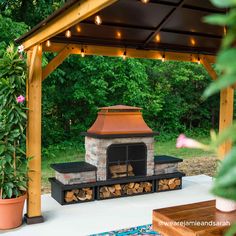 an outdoor patio with a fire place and potted plants