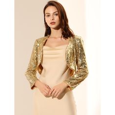 In the crop design and an open front, this sequin cardigan is perfect for parties, holidays, and clubs. This sequin shrug features a soft line, a cropped hem, and long sleeves. The soft-lined design ensures all-day comfort and the shiny sequin makes it a classic piece for parties, cocktails, gatherings, weekends, or daily wear. Charm all day long in this Sequin Jacket trimmed with crop and open front design. Trendy Gold Party Outerwear, Glitter Long Sleeve Party Outerwear, Sequin Bolero Jacket, Sequin Shrug, Fitted 3/4 Sleeve Party Shrug, Elegant 3/4 Sleeve Shrug For Spring, Shrug Jacket, Crop Design, Cardigan Shrug