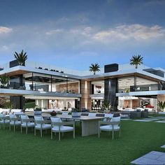 an artist's rendering of a modern house with large lawn and dining area in the foreground