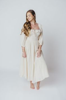 The Juliet Midi Dress is an elegant, ultra-flattering gown that's perfect for any occasion. We just love a 3/4 length sleeve, and the Juliet delivers with a loose, elastic-cuffed sleeves, plus a square neckline and smocked bodice for maximum comfort. Pair with slides for a more relaxed look, or dress it up with neutral heels! FIT: Runs true to size. MATERIAL: GARMENT DETAILS: A-line midi dress with square neckline and 3/4 length sleeves with elasticized cuffs. Features a smocked bodice, accent r Elegant Flowy Maxi Dress With 3/4 Sleeves, Spring Wedding Maxi Dress With 3/4 Sleeves, Elegant 3/4 Sleeve Midi Wedding Dress, Elegant Spring Maxi Dress 3/4 Length, Elegant Spring Maxi Dress With 3/4 Sleeves, Elegant 3/4 Sleeve Maxi Dress For Fall, Elegant Spring Midi Dress With 3/4 Sleeves, Chic Flowy Maxi Dress With 3/4 Sleeves, Flowy Brunch Dress With 3/4 Sleeves