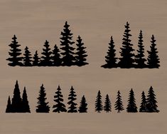 the silhouettes of pine trees are shown on wood