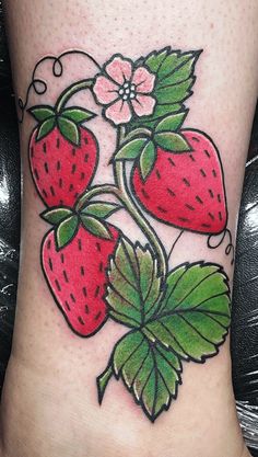 a tattoo design with three strawberries on the side of a woman's leg