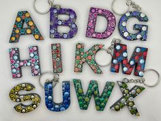 the letters and numbers are made out of glass bead beads, which can be used as key chains or pendants