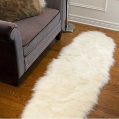 a white sheepskin rug sitting on top of a couch