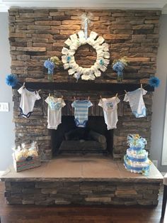 a fireplace with baby clothes hanging from it's mantle