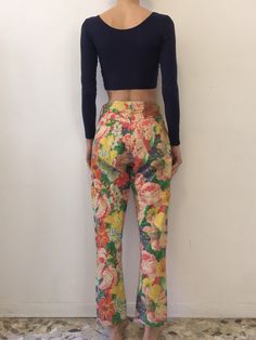 Multi color floral 1980s Kenzo Jeans! All over gorgeous floral print. Super cute summer style paired with a little crop top and beach hair. Fabric is a cotton denim. High waisted fit with five pockets and a tapered leg. Kenzo buttons up the fly - each copper button has the Kenzo logo. Kenzo face logo on back pocket. Label Kenzo Jeans, Miyuki, size US29, 100% cotton, please turn inside out and wash cool delicate and drip dry. Very good vintage condition - please note that the outside leg seam has Cotton Bottoms With Floral Print, Casual Summer Bottoms For Garden Party, Spring Floral Print Cotton Pants, Multicolor Floral Print Pants For Spring, Spring Multicolor Floral Print Pants, Multicolor Floral Print Summer Pants, Multicolor Floral Print Bottoms For Day Out, Straight Leg Cotton Bottoms With Floral Print, Retro Cotton Jeans For Spring