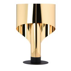 a gold lamp with black base on a white background in the style of art deco