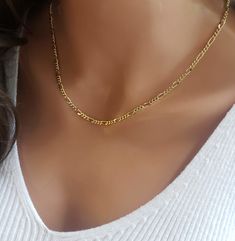 Please Note:  Our processing time is now 1 - 2 weeks before shipping.  We can no longer guarantee delivery by December 24th Gold plated figaro layering choker! This classy chain can be a standout necklace on its own or a great addition to other necklaces. The links give it a statement look when you wear it with other chains. It's made from 14K gold plated with a waterproof coating so it's safe for sensitive skin. This necklace is perfect for everyday wear, with its classic yellow gold color. IT' Cheap Gold Necklace With Figaro Chain, Cheap Gold Plated Figaro Chain Necklace, Cheap Silver Figaro Chain Necklace, Cheap Figaro Chain Necklaces For Gifts, Luxury Figaro Chain Jewelry For Women, Trendy Layered Figaro Chain Necklace, Layered Figaro Chain Necklace As Gift, Dainty Layered Necklace With Figaro Chain, Dainty Figaro Chain Necklace