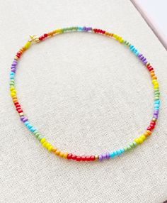 Seed Bead Choker Necklace 17 inches total length Perfect for layering with your favorites Glass Beads with Gold plated lobster clasp closure These little seed beads are 4mm wide A short extender tail will be added so you can adjust the length a little if you like Colorful Adjustable Necklace With Tiny Beads, Colorful Adjustable Tiny Bead Necklaces, Adjustable Rainbow Necklaces With Spacer Beads, Rainbow Heishi Beads Necklace With Spacer Beads, Rainbow Round Bead Adjustable Necklace, Adjustable Rainbow Round Bead Necklaces, Rainbow Necklaces With Tiny Round Beads, Rainbow Necklace With Tiny Round Beads, Dainty Multicolor Necklaces With Spacer Beads