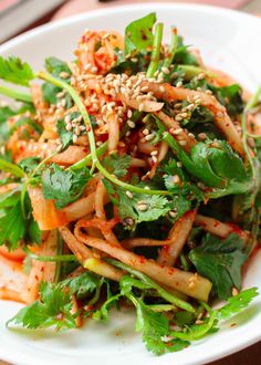 a white plate topped with salad and veggies