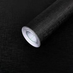 a roll of black fabric on top of a table