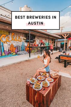 a woman sitting on top of a wooden table with food in front of her and the words best brewers in austin above it