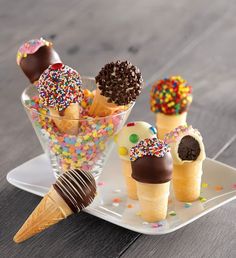 several ice cream cones with sprinkles and chocolate on them