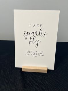 a card with the words i see sparks fly on it, sitting on top of a table